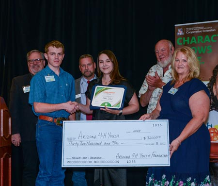 Paden Dillard from Pinal County receives a scholarship from the AZ 4-H Youth Foundation Executive Committee and Trustees during the 2024 4-H Clover Ball on June 2nd.