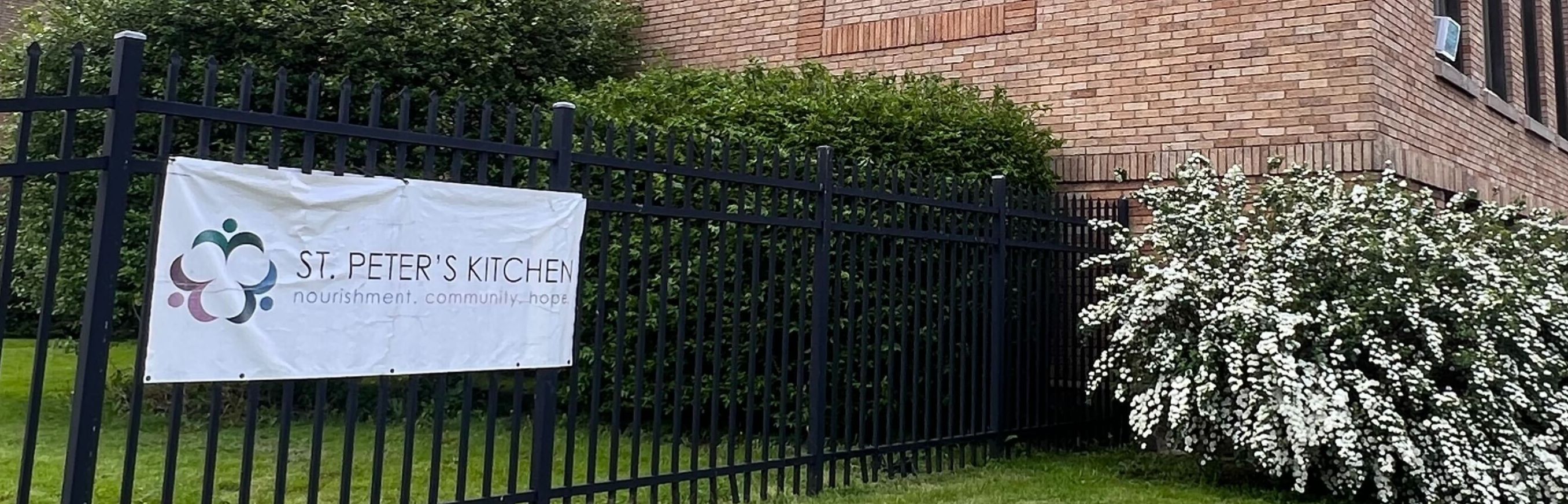 image of volunteers packing a box with canned goods
